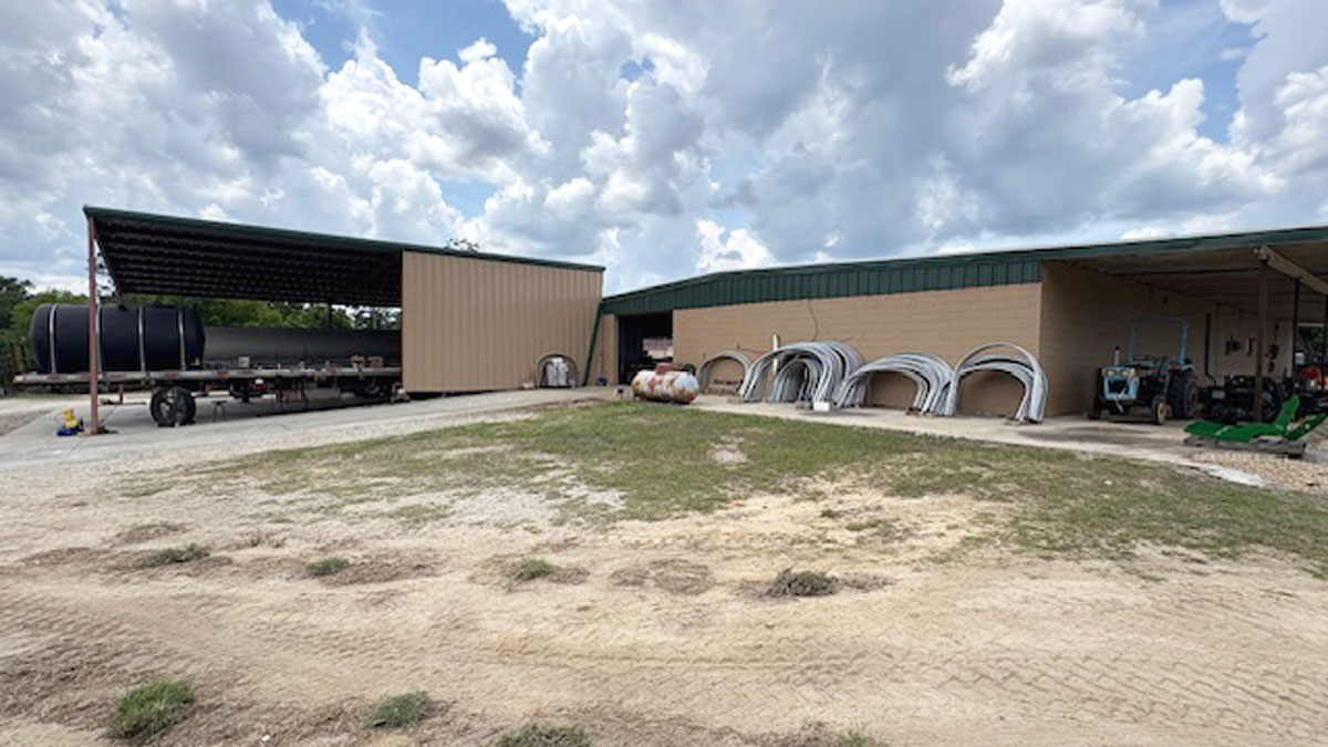 Chemical Containers Lyons store - outside machine shop with spray tank bands