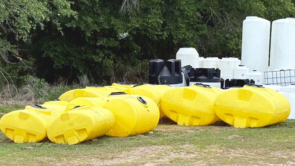 Chemical Containers Lyons store - outside yellow elliptical spray tanks for sale