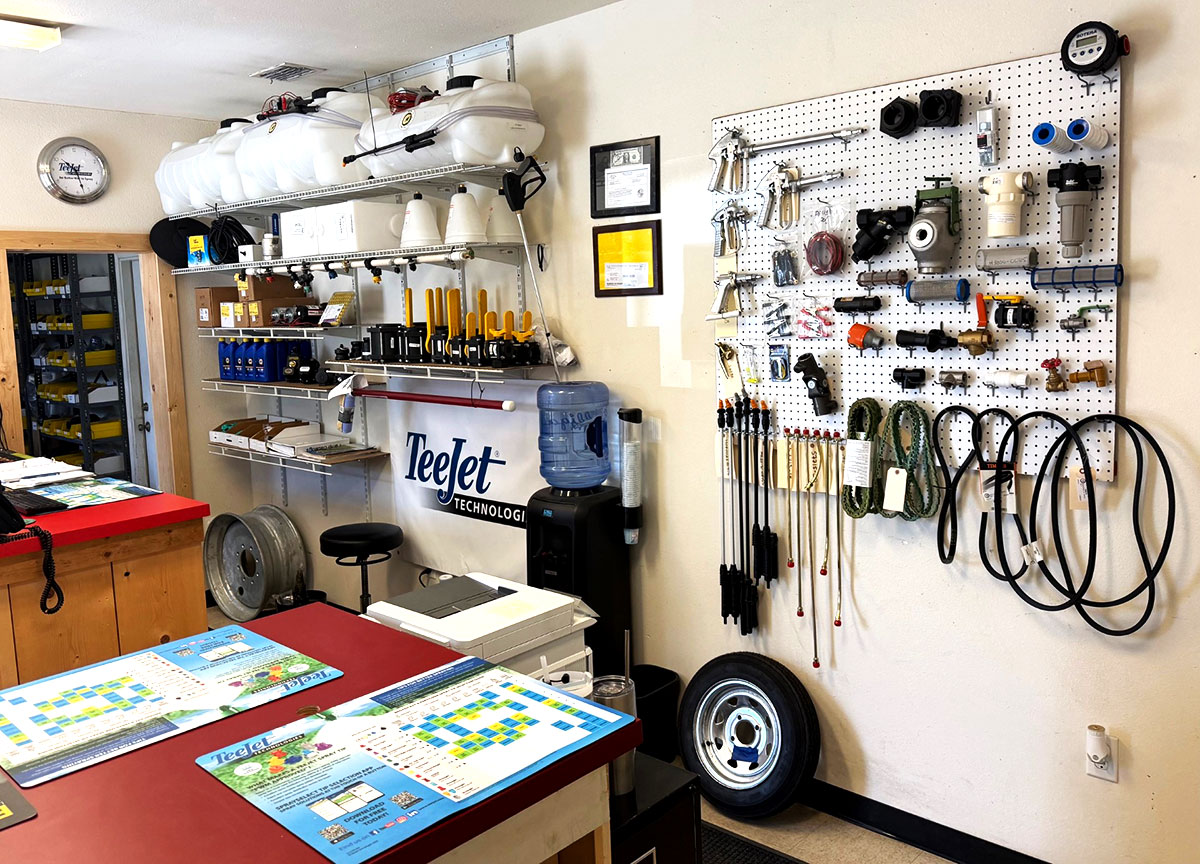 Chemical Containers Plant City store - spray tanks and wands display on side wall